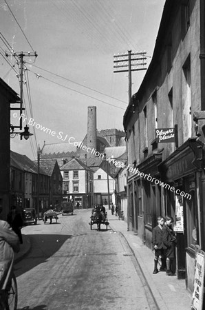 STREET WITH ROUND TOWER IN BACKGROUND. IRISHTOWN